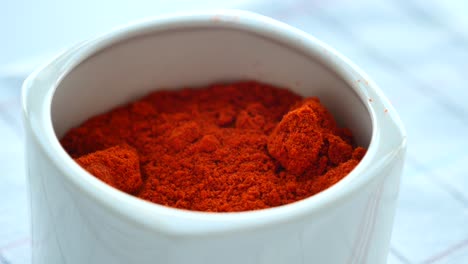 close-up of paprika powder in a white bowl