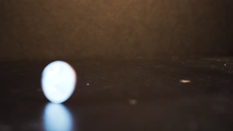 a quarter of american dollar spinning on a table top