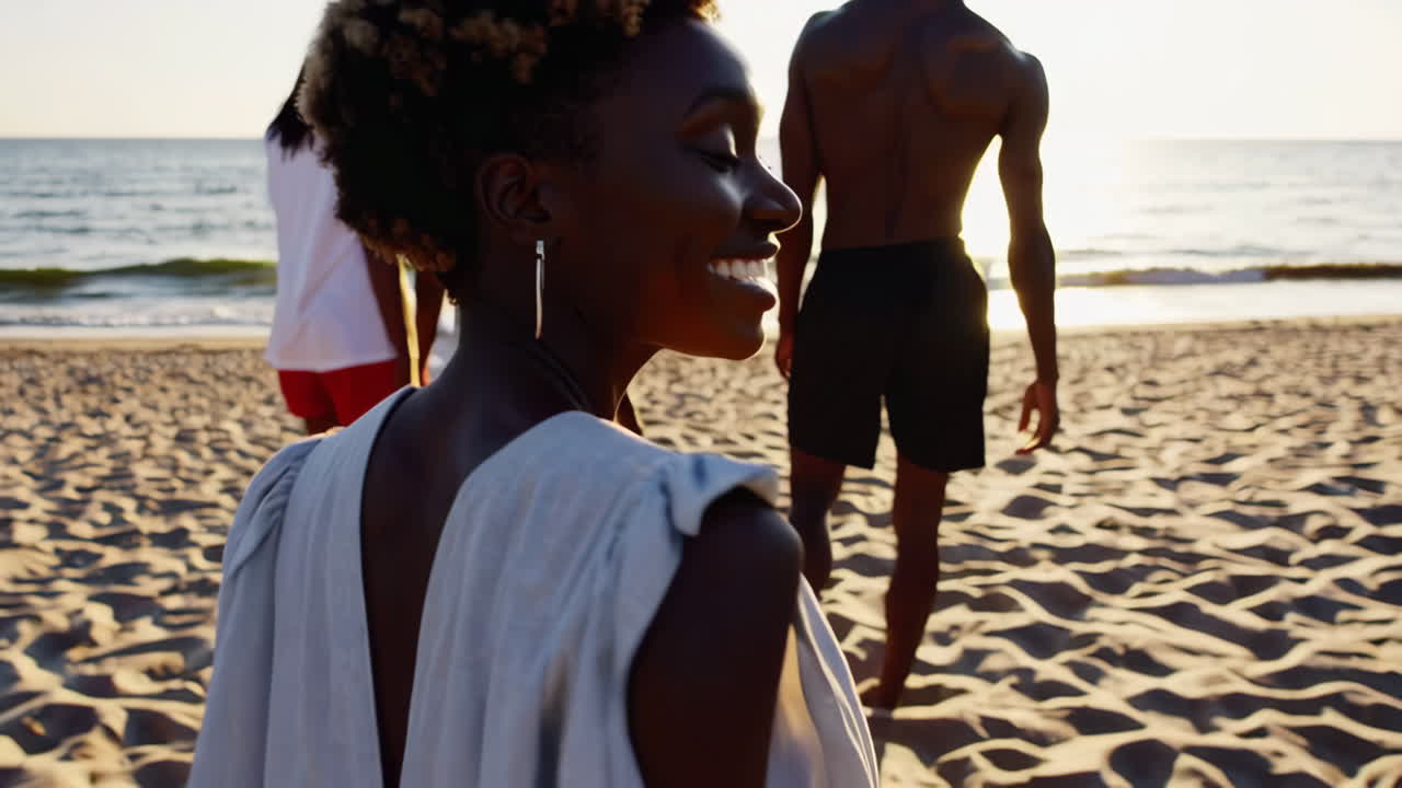 Friends enjoying a serene walk on the beach at sunset