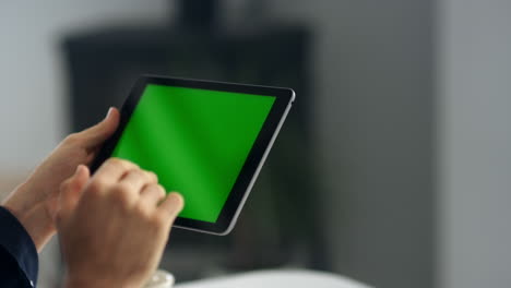 Close-up-view-of-business-man-making-video-call-on-tablet-with-green-screen