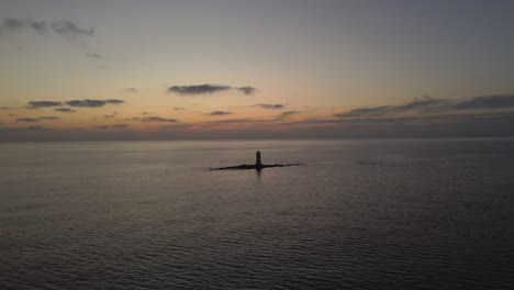 astonishing aerial approach lighthouse in middle of rocks, sea landscape