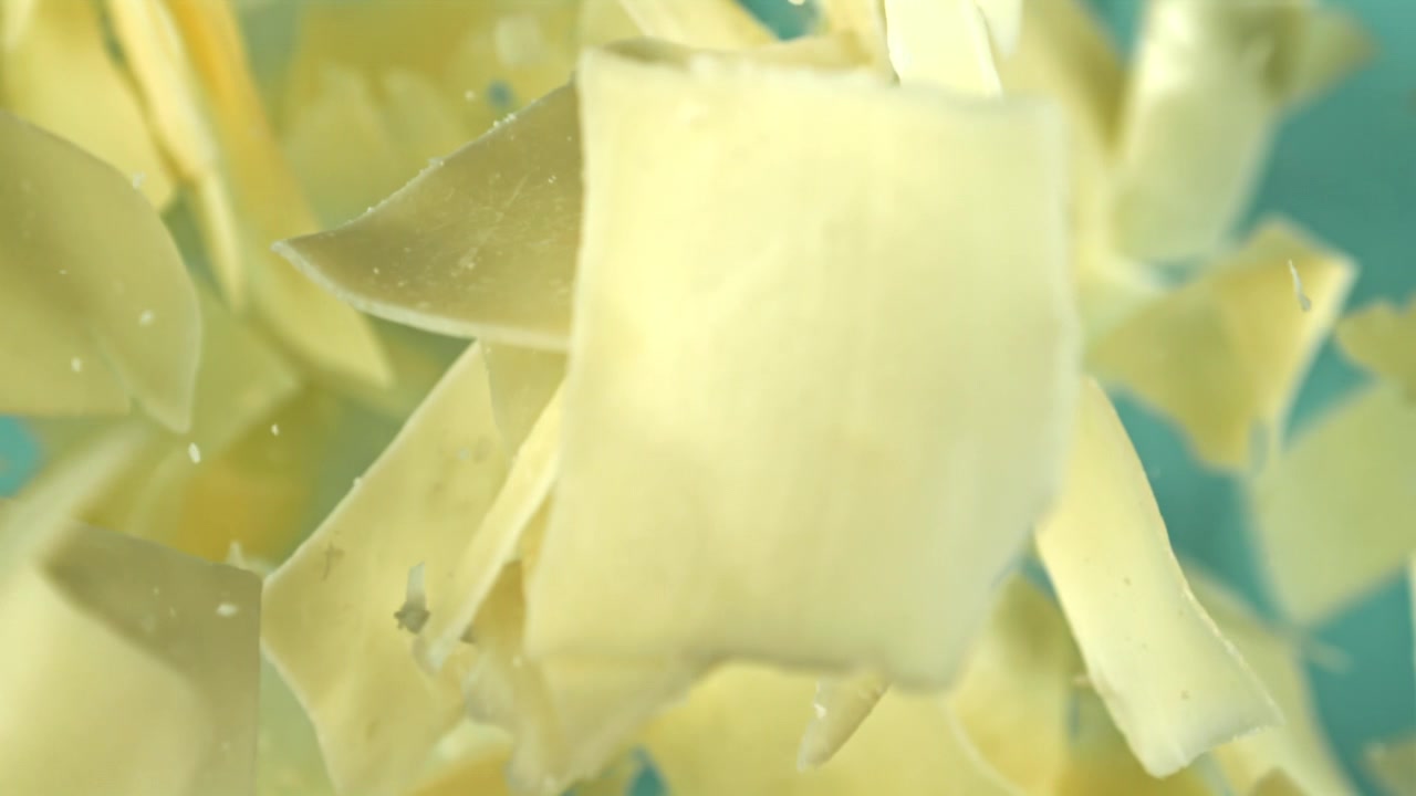 Scaglie di cioccolato bianco che cadono in super slow motion.