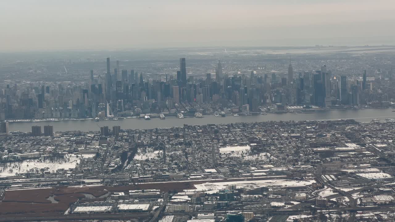 New York City winter skyline with Hudson River view from plane window