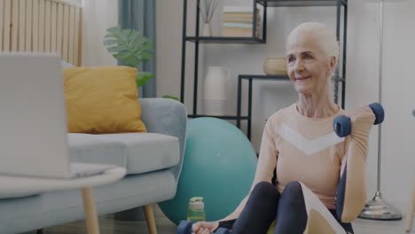 senior woman doing online fitness workout at home