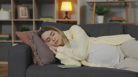 pregnant woman sleeping on couch