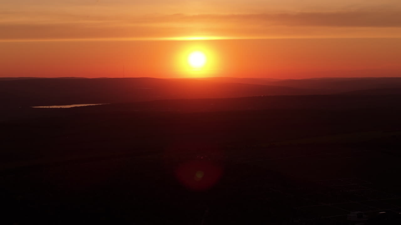 Scenic view of a distant city at sunset
