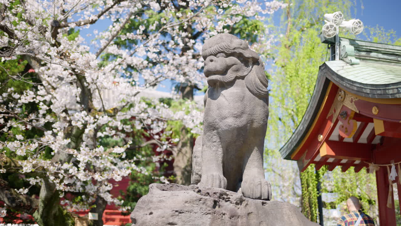 Stone sculpture at the Senso-ji temple in daylight in Tokyo, Japan