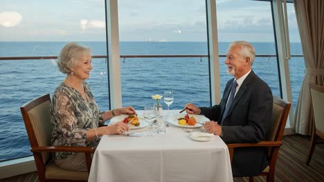 a romantic dinner for two: seniors enjoying fine cuisine with a scenic ocean view during a special dining experience