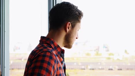 ejecutivo masculino mirando por la ventana 4k