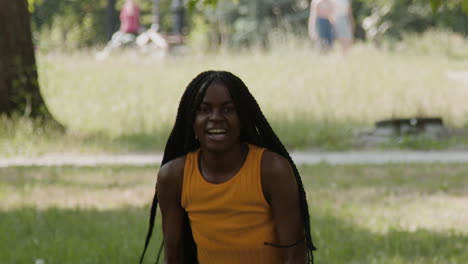 energetic woman playing football and reacting in a park