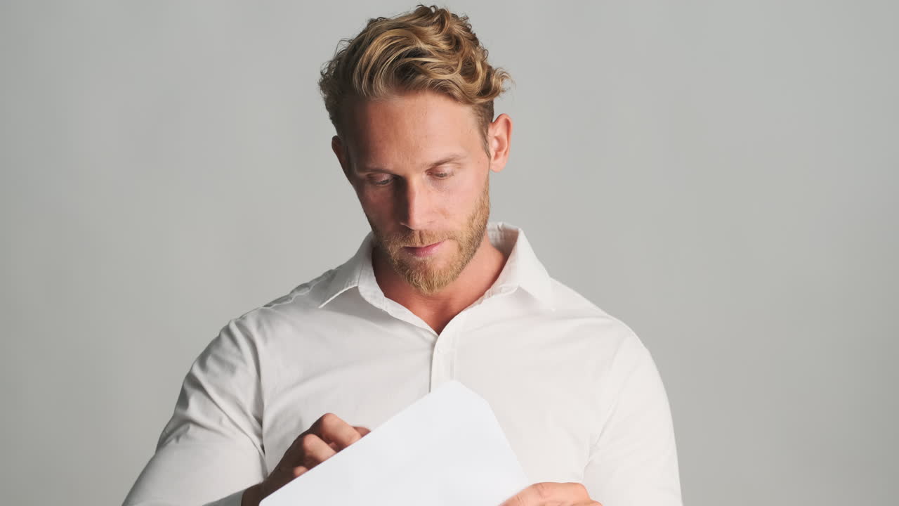 Nervous man reading papers and celebrating