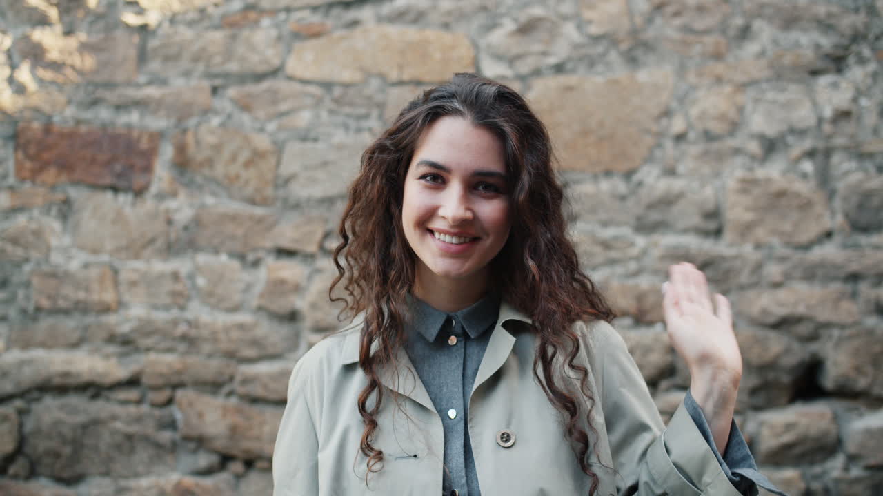 Young Woman Smiling and Waving