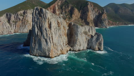 Fantastic-aerial-view-travelling-out-to-Pan-di-Zucchero-on-the-island-of-Sardinia,-near-Masua