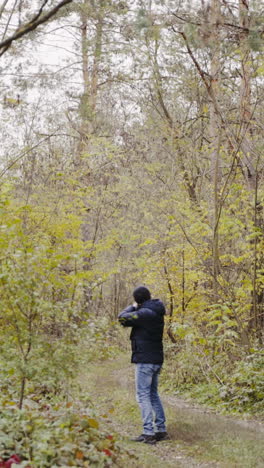 Hunter with gun on forest. Close up of the hunter man shooting with hunting rifle on nature