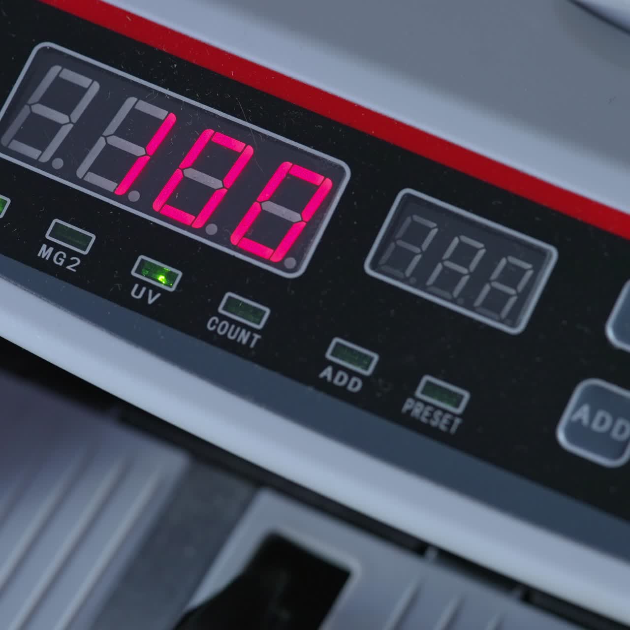 Numbers growing quickly on the display of cash counting machine. American dollars being counted in equipment. Close up