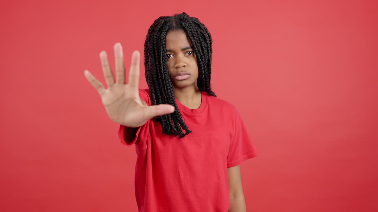 Woman with Braids Holding Hand Up