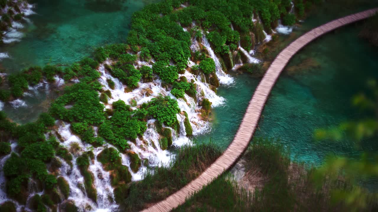 Plitvice Lakes, Croatia. Waterfalls flowing gently at wooden path. Blue pool, turquoise water