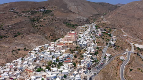 aerial: flying over the catholic saint george church of ermoupoli city in syros island, greece on a sunny day