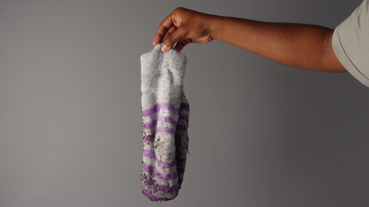 Dirty Sock Held in Hand