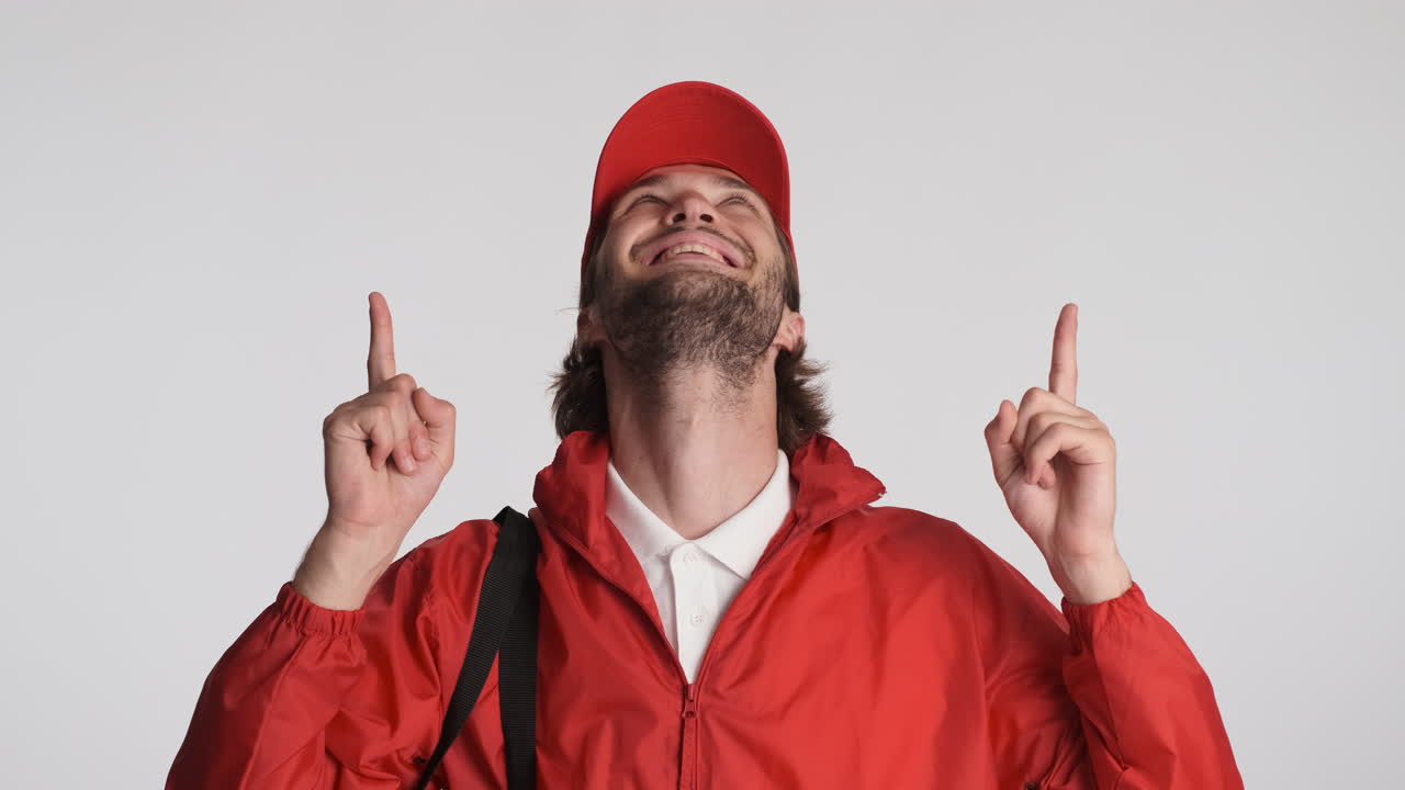 Caucasian delivery man in front of camera on white background.