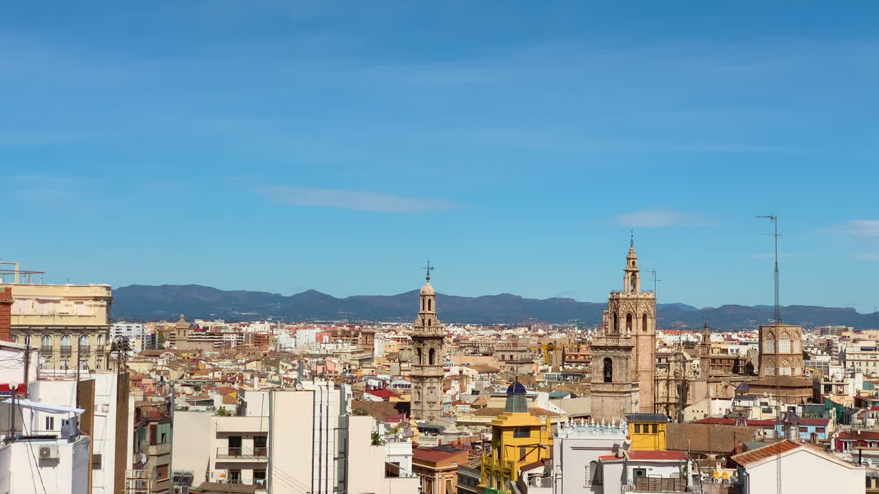 Panoramic view of the Valencia skyline from a penthouse in the town hall square on a sunny day with mountains in the background