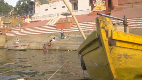 panning shot of yellow boat and ghat