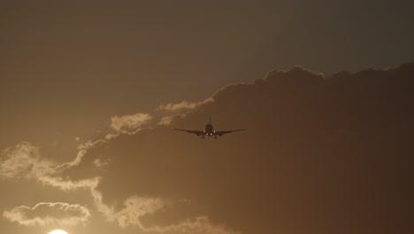 plane flying in sky with warm evening light