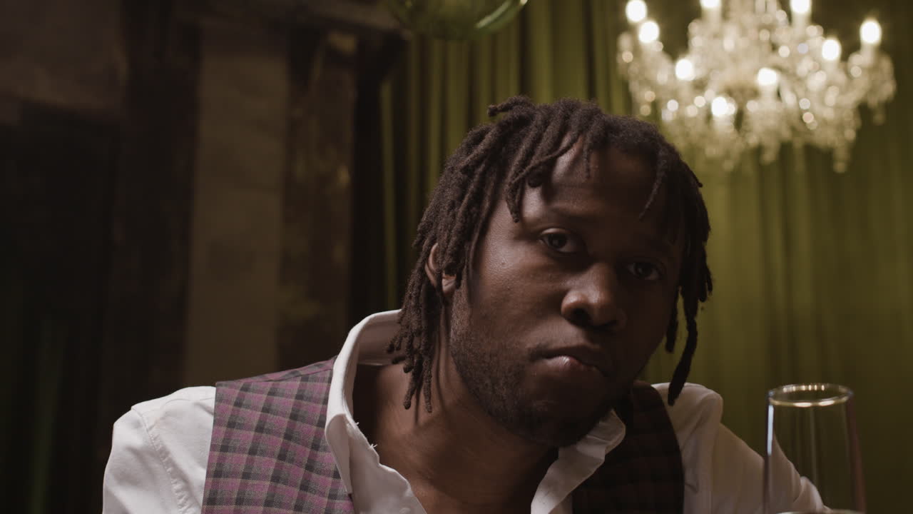 Man with dreadlocks eating grapes