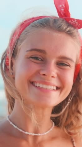 young woman expresses joy with heart gesture at sunset on the beach