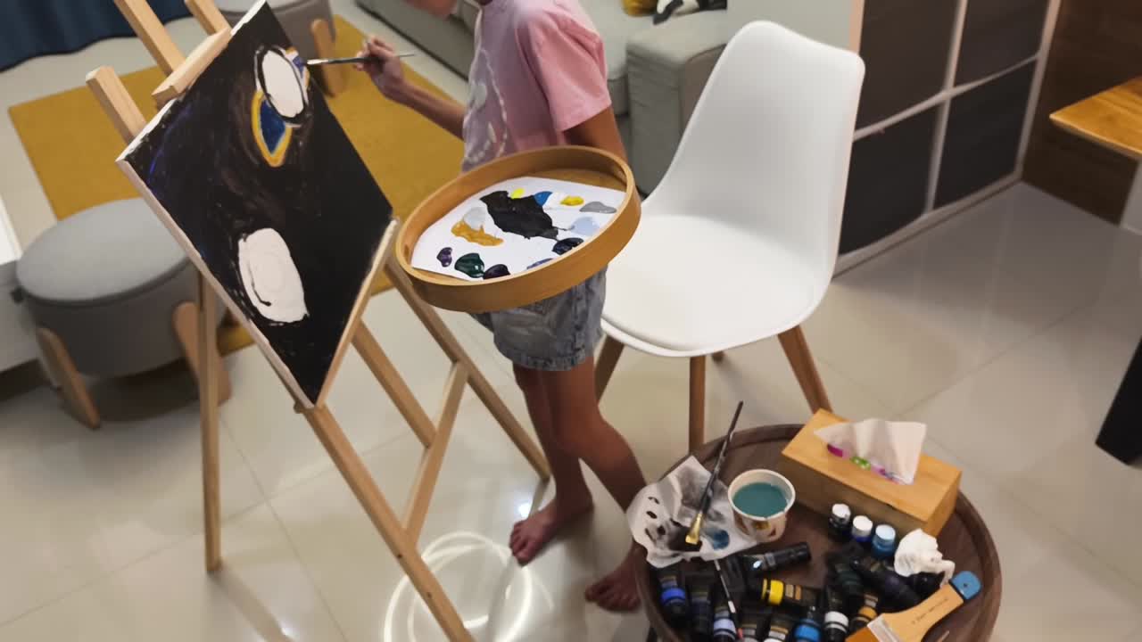 Child painting abstract art at home studio