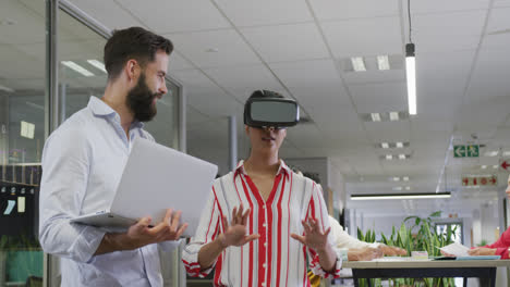 Happy-diverse-male-and-female-business-colleagues-using-vr-headset-in-office