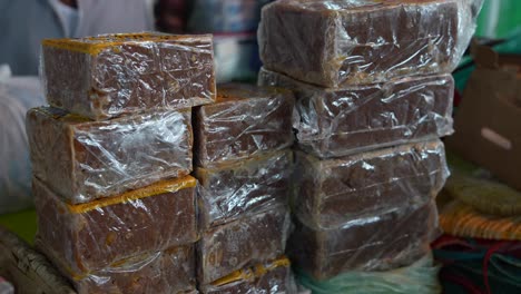 panela, rapadura or chancaca blocks at local farms market in south america. isolated. close up