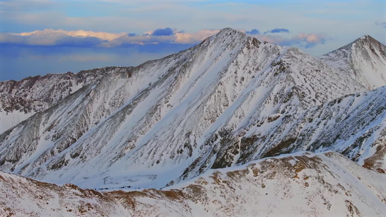 Grays and Torreys 14er Peak Loveland Pass winter spring golden hour sunset Colorado aerial drone panorama landscape Arapahoe Basin backcountry deep powder snow Rocky Mountains pan left motion