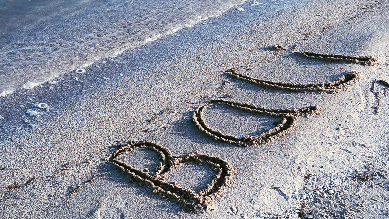 Inscription Bali on sandy beach. Inscription on sand, the beach