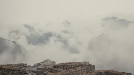 historic sanctuary of machu picchu with cloudscape in the background in the andes mountains in peru. aerial shot