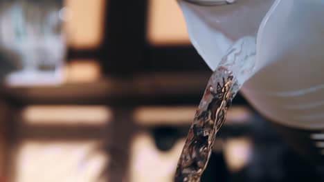 pouring water from a kettle in slow motion