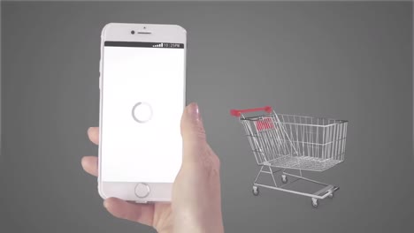 animation of person holding smartphone with online shopping on screen and trolley on grey background