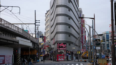 slow motion, tilt shot, of traffic on the ueno shopping street, at a cloudy, autumn day, in tokyo, japan