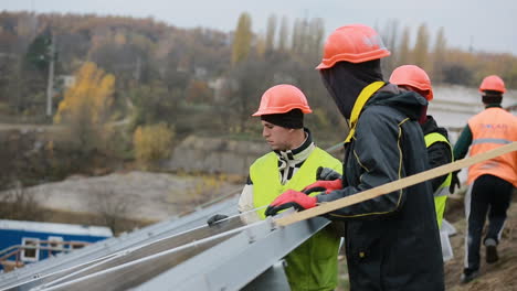 men working at solar station. vinnitsa, ukraine - november 2017: solar panel technician installing solar panels