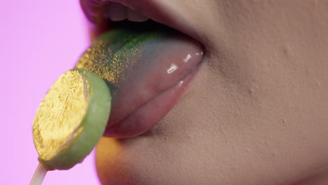 mujer lamiendo helado con su lengua, boca en primer plano en fondo verde