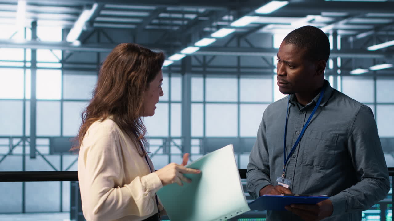 los administradores alegres se reúnen en el centro de datos para revisar los informes, haciendo un apretón de manos