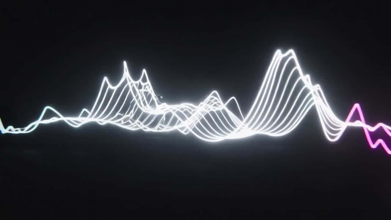 Vertical video: Bursting flash pushing cyan magenta waves into sparks forming white ribbons in void