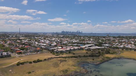 drone footage of the approach towards melbourne cityskyline from the jawbone marine sanctuary in williamstown, melbourne in victoria, australia.