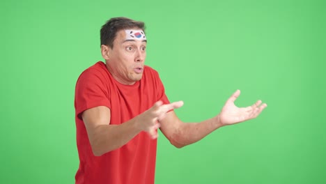 Man cheering for South Korea, angry with the decision of referee