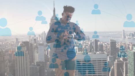 animation of african american businessman using smartwatch over cityscape