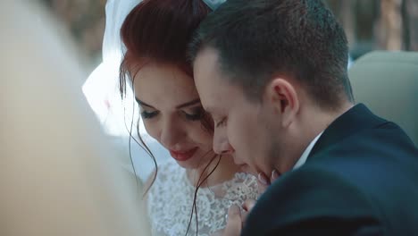 newlyweds sitting car convertible look at each other interact close-up slow motion