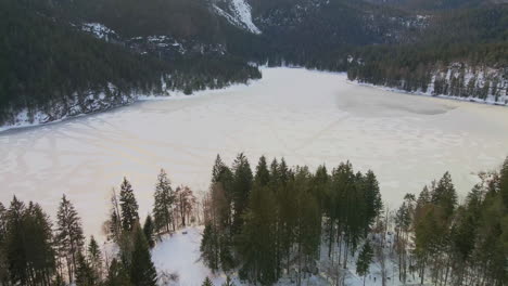 Frozen-Lago-di-Tovel-Near-Towering-Dolomites-Mountains-In-Trentino,-Italy