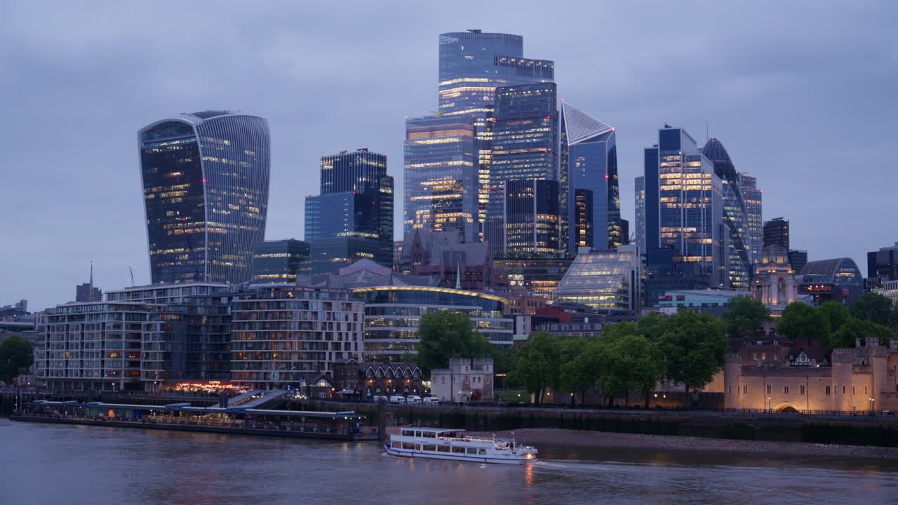 Cityscape view showing the Thames River, modern skyscrapers, including the Walkie Talkie building, and the Tower of London