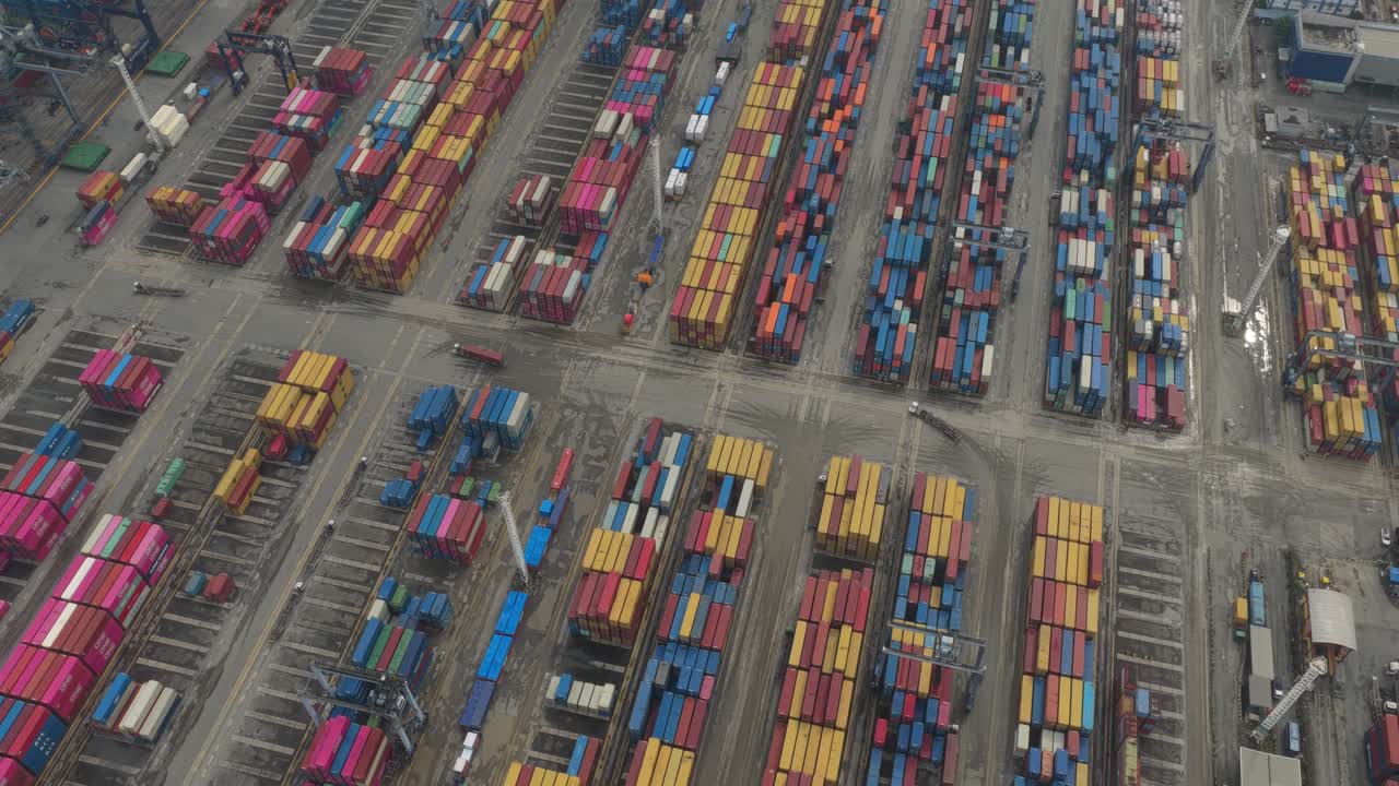 High-angle view of dynamic seaport with stacked containers and cargo vessels