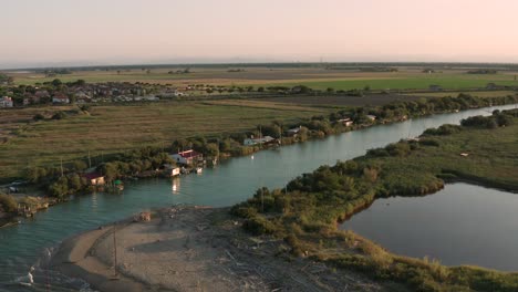 aerial shot of the valleys near ravenna where the river flows into the sea with the typical fishermen's huts